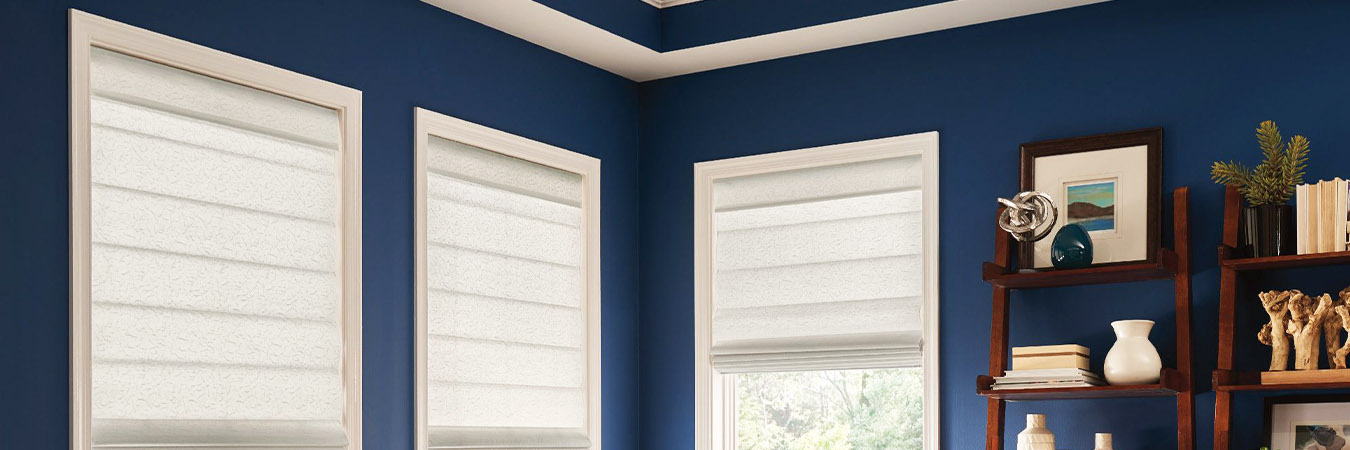 White cordless Roman shades in a blue living room