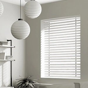 White blinds with gray walls. In a corner of a modern living room.